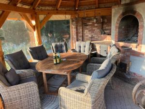 an outdoor patio with a wooden table and chairs at Studio z kominkiem Leśna sauna i balia Cieszyn Wisła Ustron w zasięgu ręki in Simoradz