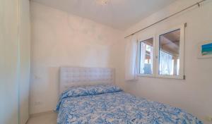 Postel nebo postele na pokoji v ubytování Appartamento Terrata Golfo Aranci + 3 fotografie