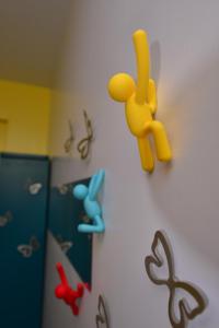 a yellow toy on a wall with magnets on it at STSP Guest House in Xinshi