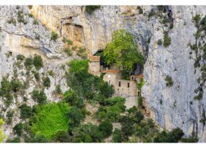 a monastery built into the side of a mountain at Roulotte pour amoureux de la nature in Bugarach