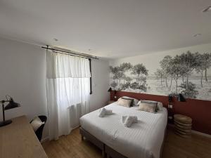 a bedroom with a bed and a large window at Le Clos Minard in Plouézec +43 photos