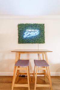a table with two chairs and a sign on the wall at Sunset Suite Central to I75 airport & downtown in Punta Gorda