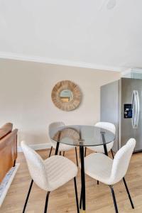 a dining room with a glass table and chairs at Sunrise Suite Central to I75 airport & downtown in Punta Gorda