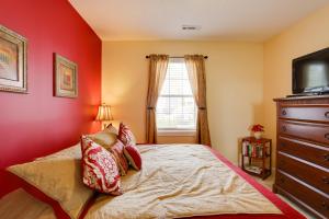a bedroom with red walls and a bed with pillows at 2 Mi to Broadway at the Beach Myrtle Beach Condo in Myrtle Beach