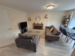 a living room with two couches and a television at Cosy and Nice Apartment in Borehamwood