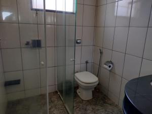 a bathroom with a toilet and a glass shower at Casa na Serra da Canastra in São Roque de Minas +17 photos
