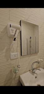 a bathroom with a sink and a mirror at VIP Hotel Amman in Amman +44 photos