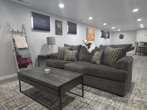 a dog sitting on a couch in a living room at Purple Mountain Majestic Retreat in Colorado Springs
