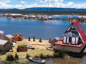 a small island in the middle of a body of water at Titicaca UTJAWI LODGE in Puno