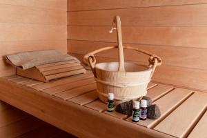 a bathtub with a bucket and spices on it at Broomfeild Bothy Comes with a Sauna in Boat of Garten