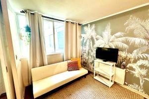a living room with a couch and a flat screen tv at Santiago Urbano Apartments - Centric Santiago in Santiago