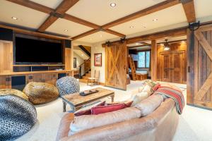 a living room with a couch and a tv at Alpenglow by Exceptional Stays in Telluride