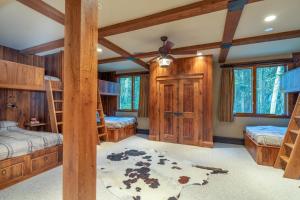a bedroom with bunk beds and wooden walls at Alpenglow by Exceptional Stays in Telluride