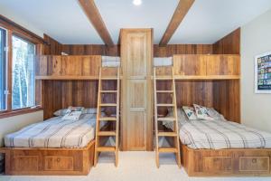 two bunk beds in a room with wooden walls at Alpenglow by Exceptional Stays in Telluride