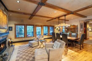a dining room with a table and chairs and a fireplace at Alpenglow by Exceptional Stays in Telluride