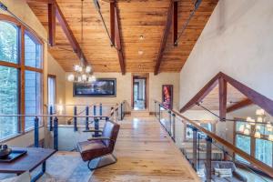 a staircase in a house with a wooden ceiling at Alpenglow by Exceptional Stays in Telluride