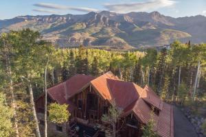 an aerial view of a house with mountains in the background at Alpenglow by Exceptional Stays in Telluride