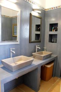 a bathroom with two sinks on a counter at Villa Penelope - Marathopoli in Marathopolis