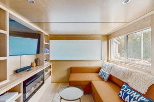 a small living room with a couch and a tv at Cottage Retreat in Colchester