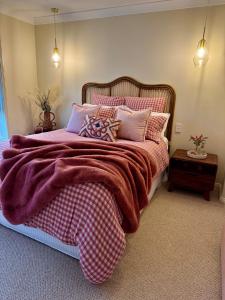 a bedroom with a large bed with a purple blanket at Budgaribah in Old Bar