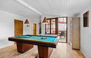 a pool table in the middle of a room at 4 Bedroom Awesome Home In Rudkøbing in Rudkøbing +17 photos