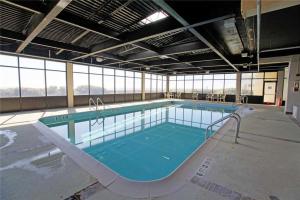 a large swimming pool in a large building at Pelican Watch 706: Sea You Next Time by Carolina Beach Realty in Carolina Beach