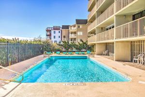 a swimming pool in front of a apartment building at Pelican Watch 706: Sea You Next Time by Carolina Beach Realty in Carolina Beach +31 photos