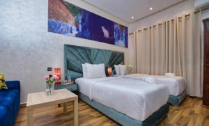 Postel nebo postele na pokoji v ubytování Hotel Dar Annasr