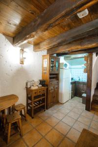 a kitchen with a table and a refrigerator at Alojamento Casas da Serra in Porto Santo