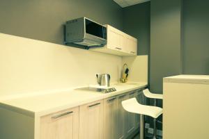 a kitchen with a counter with a computer on top of it at Apartment on Alekseyeva, 49 by KrasStalker in Krasnoyarsk