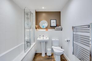 a white bathroom with a sink and a toilet at Penthouse Apartment - City Centre - Secure Parking, Balcony, Self-Check-In, Fast Wifi and Smart TV with Netflix by Yoko Property in Milton Keynes