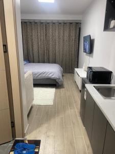 a small room with a bed and a sink at Taurus residences B2-9 near JKIA , SGR and expressway transit stay in Syokimau