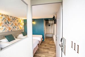 Postel nebo postele na pokoji v ubytování Kyriad Valenciennes Sud - Rouvignies