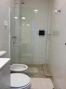 a bathroom with a shower and a toilet and a sink at Espacio Lavalle-Temporario Ctes in Corrientes