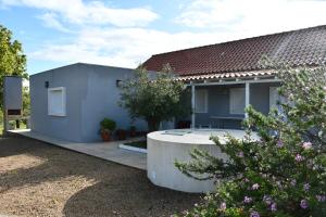 a blue house with a circular driveway at Casa do Avô Ezequiel in Vendas Novas