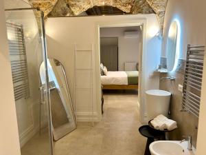 a bathroom with a shower and a sink and a bed at Addimura rooms in Palermo +23 photos