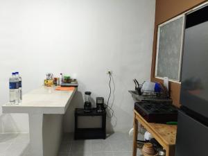 a kitchen with a white counter top and a desk at White apartment in Palenque
