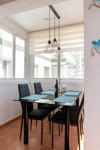 a dining room with a table and chairs at Apartamento ROMA in Torre del Mar