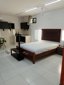 a bedroom with a bed in a room with a kitchen at Cabinas Dormi Bene in Miramar +37 photos