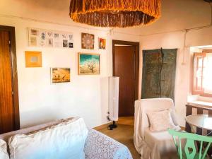 a living room with a couch and a chandelier at Casa do Lado in Reguengo +45 photos
