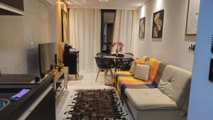 a living room with a couch and a table at Luxury Paiva Flat in Recife