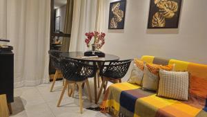 a living room with a table and a couch at Luxury Paiva Flat in Recife