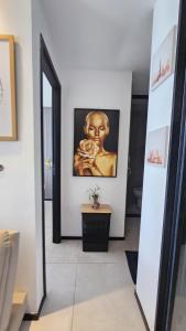 a hallway with a painting of a woman on the wall at Luxury Paiva Flat in Recife