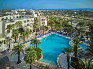 an overhead view of a large swimming pool with palm trees at TUI SUNEO Palm Beach Skanes - All Inclusive in Monastir