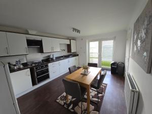 a kitchen with a table and chairs in a room at Bridge View Stayz in Plymouth