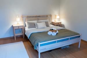 une chambre avec un grand lit avec deux tables de nuit dans l'établissement Beachfront Costa Nova Villa - 3 BR Apartment, à Gafanha da Encarnação