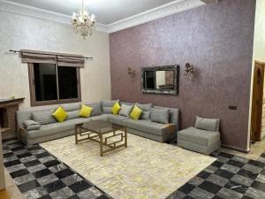 a living room with a couch and a table at Villa haut standig 2000 m2 in Marrakesh