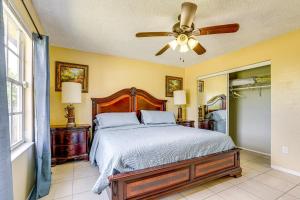 a bedroom with a bed and a ceiling fan at Mins to the Coast Port St Lucie Home with Lanai! in Fort Pierce
