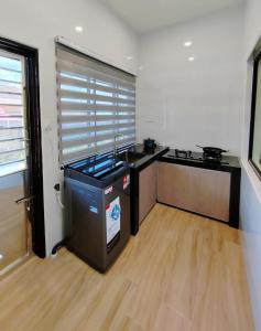 a kitchen with a sink and a counter top at Green Homestay 3Br3Ba at Pinang in Kluang +10 photos