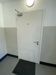 een witte deur in een kamer met een licht bij Old Town Quiet Rooftop Studio Apartment in Rīga